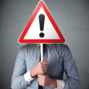 depositphotos_57233845-stock-photo-businessman-holding-an-exclamation-road